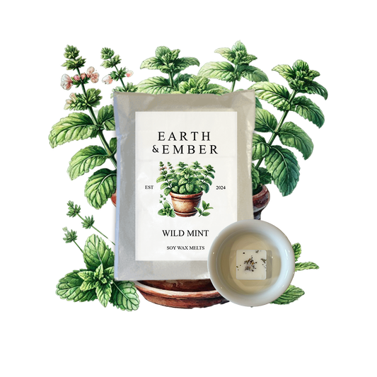 Product display with 'Earth & Ember' wild mint candle soy wax melt and framed print surrounded by mint plants. Mint scent